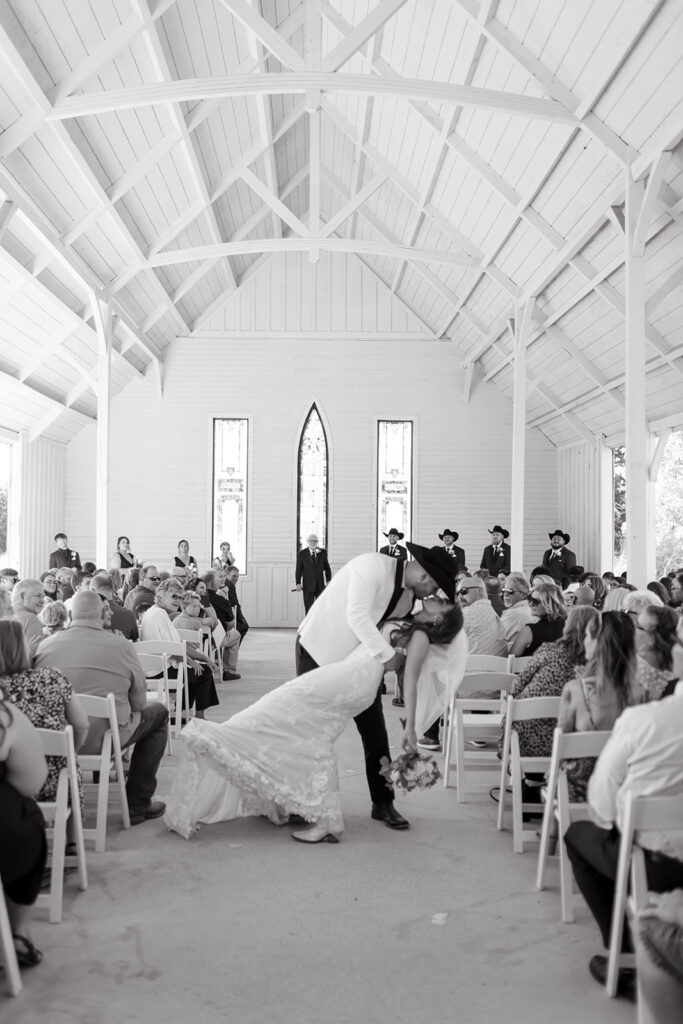 Bride and groom share their first kiss in Stone Hill Chapel