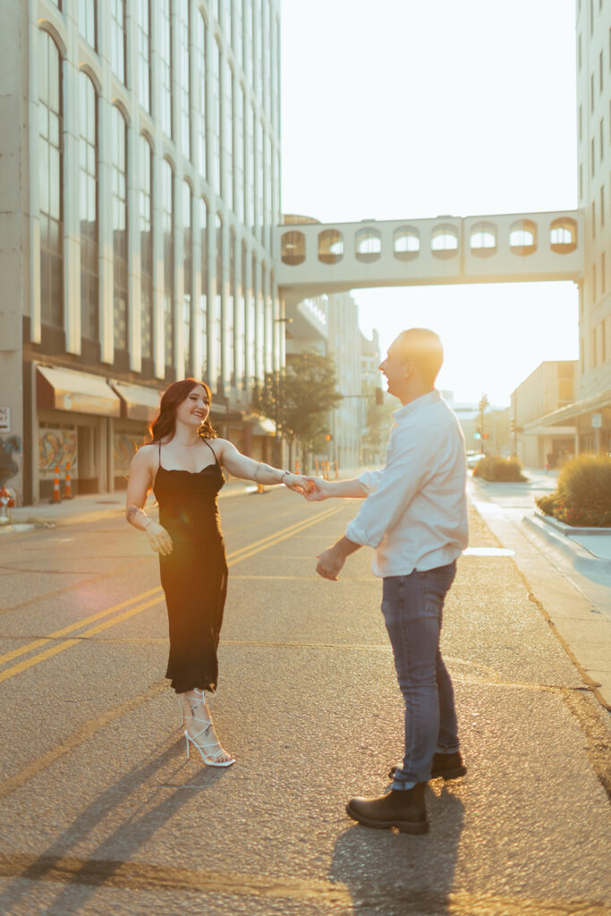 couple dances in the street during golden hour