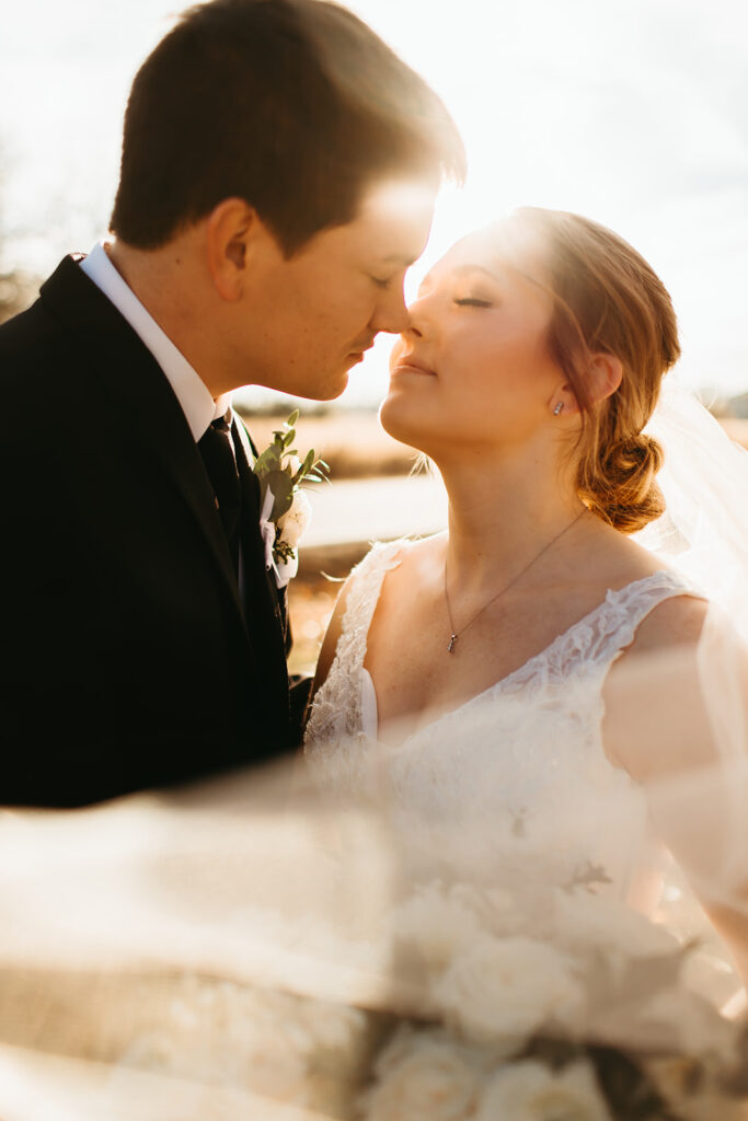 bride and groom kiss at golden hour