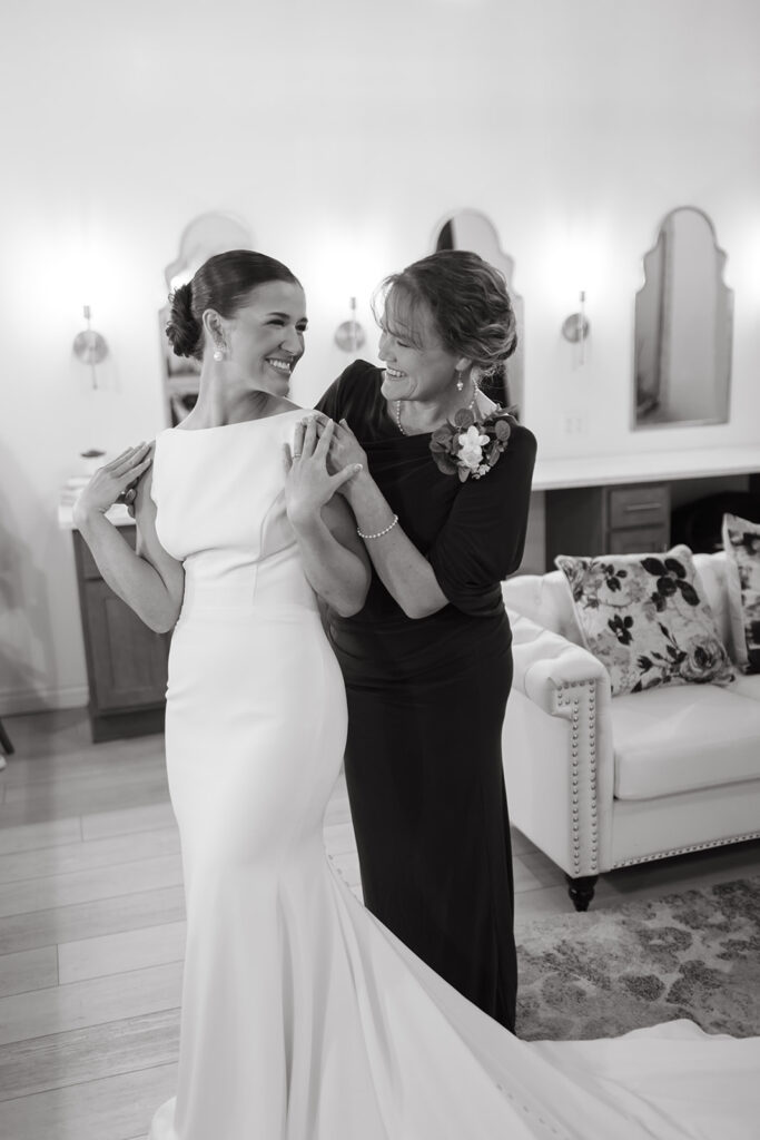 Bride and her mother sharing a moment in the bridal suite