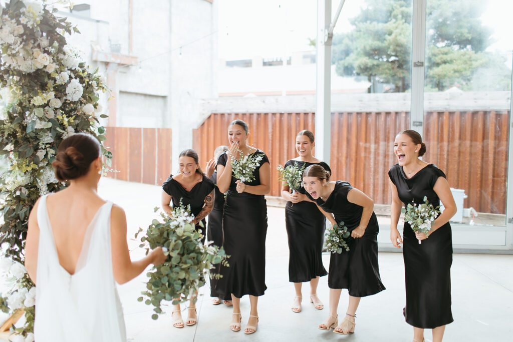 Bride does a first look with her bridesmaids as they look ecstatic