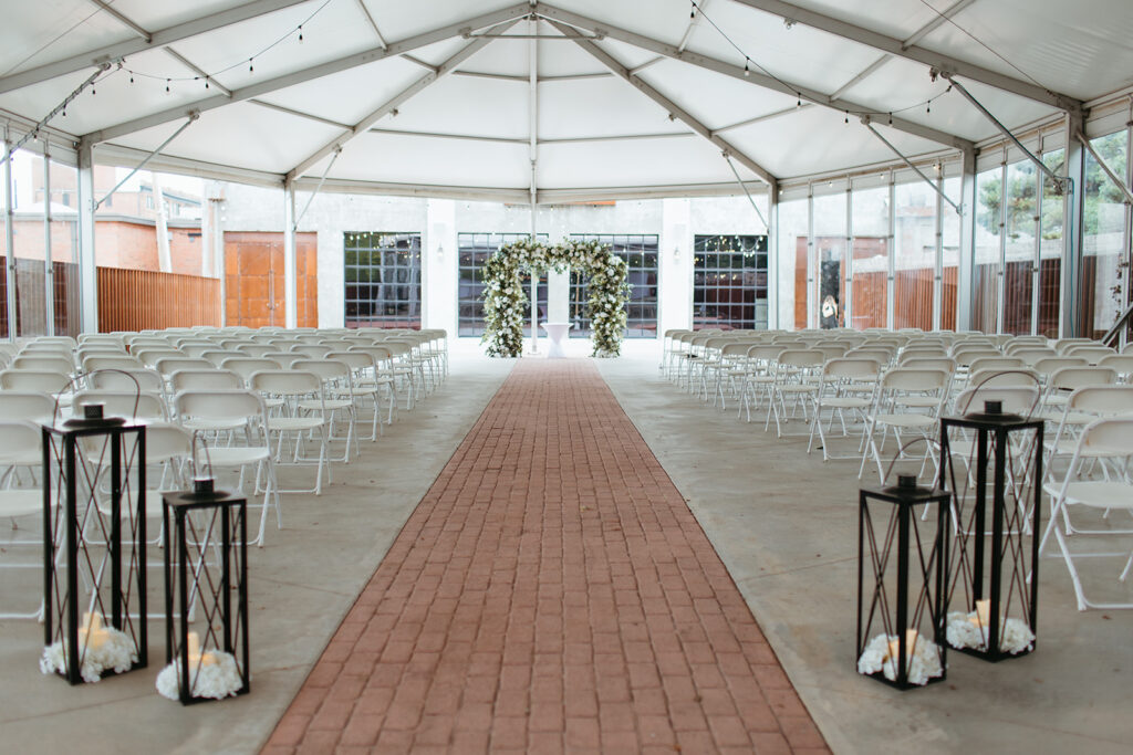 A behind the scenes, look of the ceremony set up on the patio at brick and mortar venue