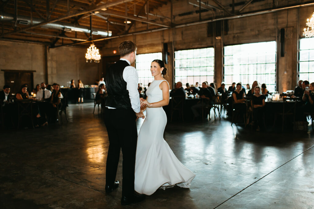 Bride and groom's first dance in the brick and mortar venue in Wichita, Kansas