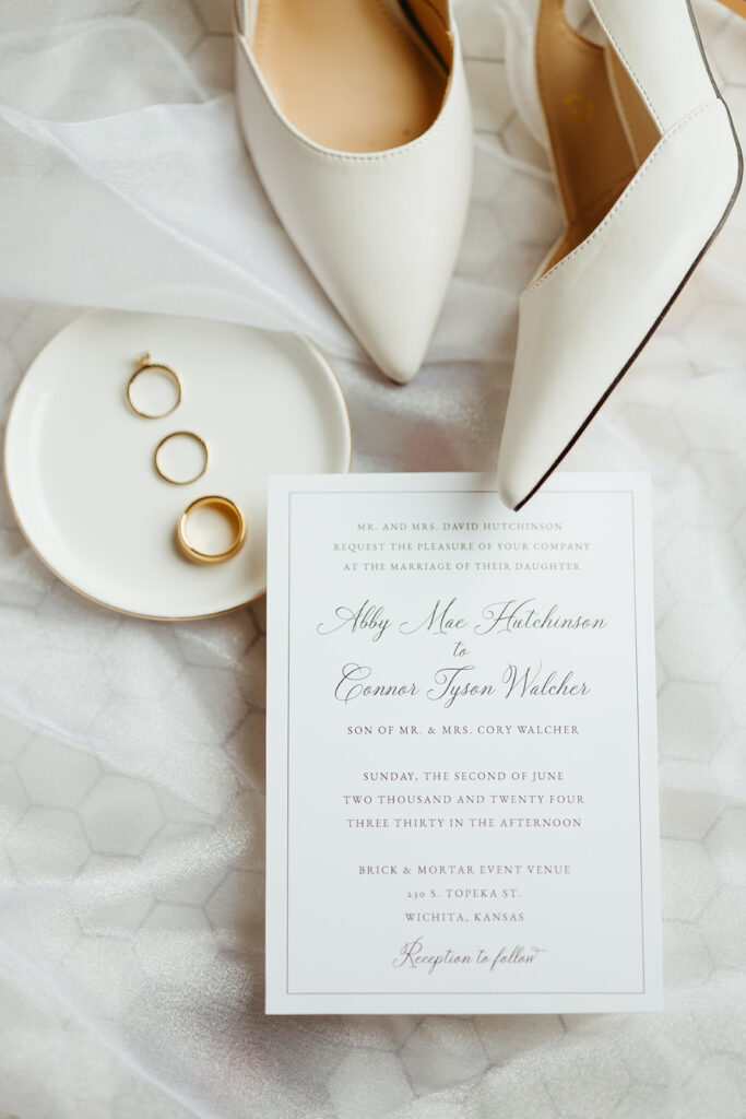 Classy white wedding details in a flat lay