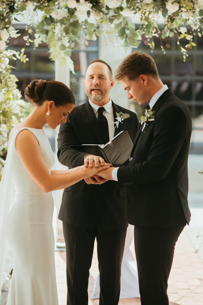 Bride and groom share their vows at their brick and mortar venue wedding ceremony