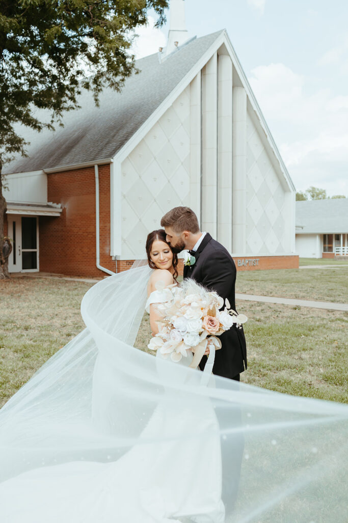 Bridal portraits in front of the church where the bride and grooms Wichita wedding ceremony was held