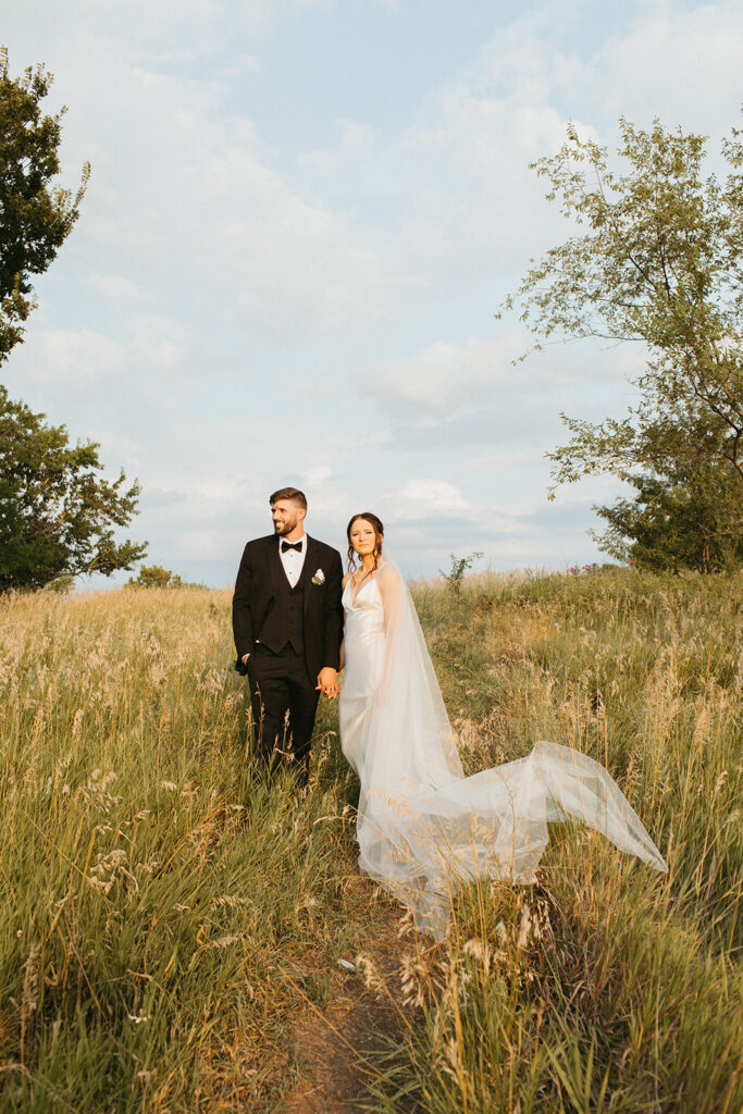 Bride and groom keep a focus on bridal portraits on their 90s style wedding day