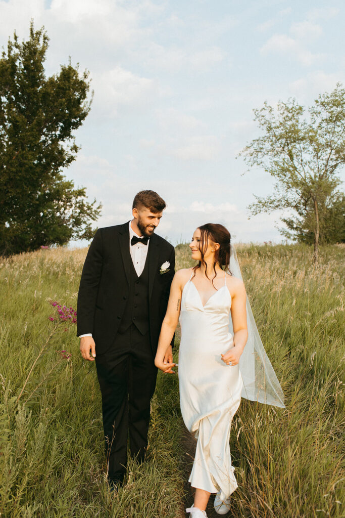 Bride and groom keep a focus on bridal portraits on their 90s style wedding day