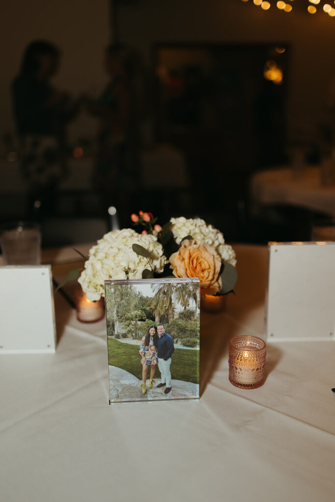 A photo of the couple as an engagement party table centerpiece