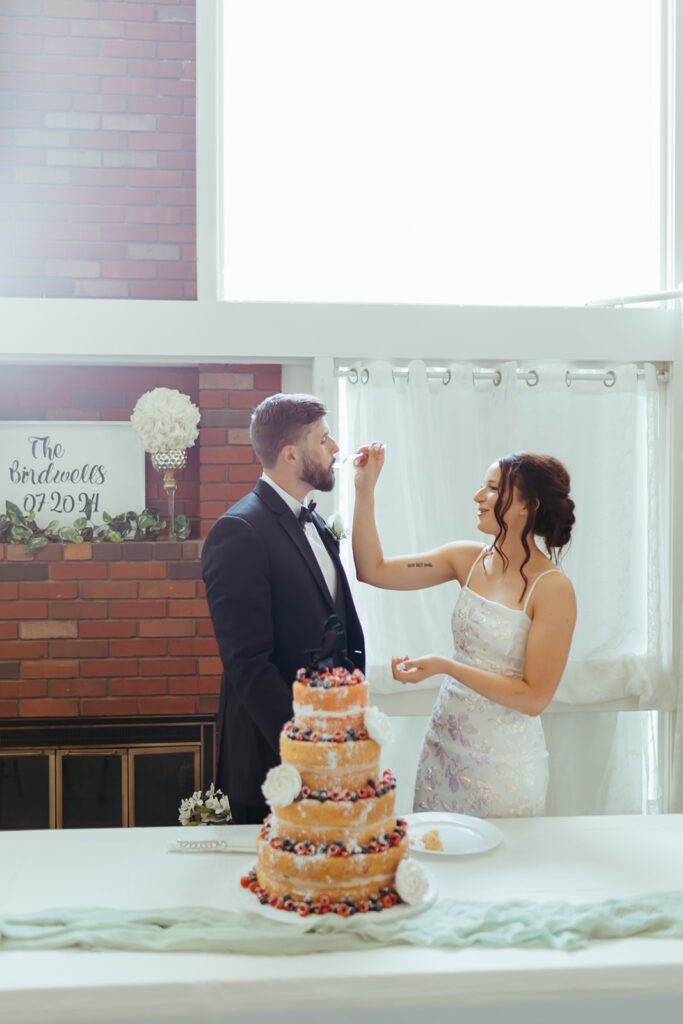 Bride and groom cut their cake at their 90s style cake reception