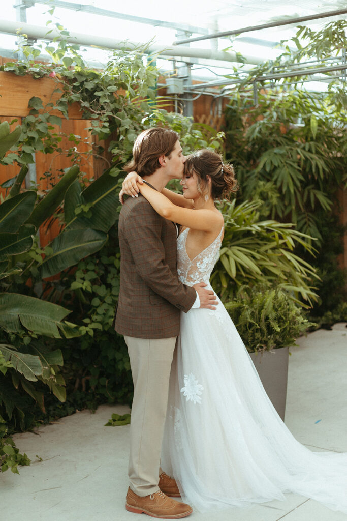 Bride and groom portraits in the greenhouse at Atreeum in Wichita