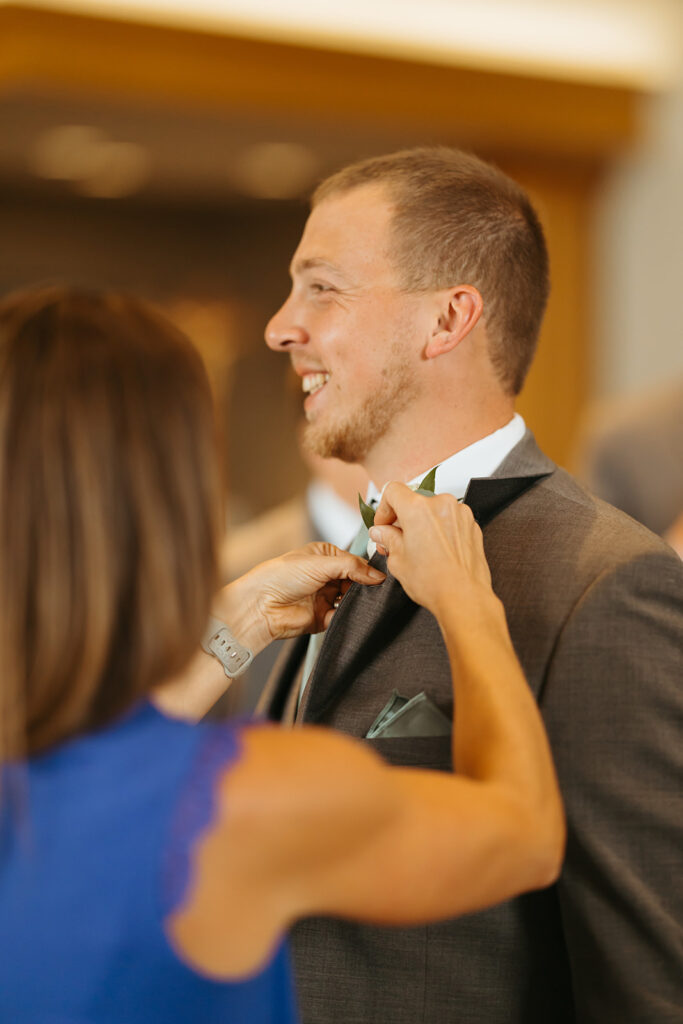 Second photographer captures groom getting ready