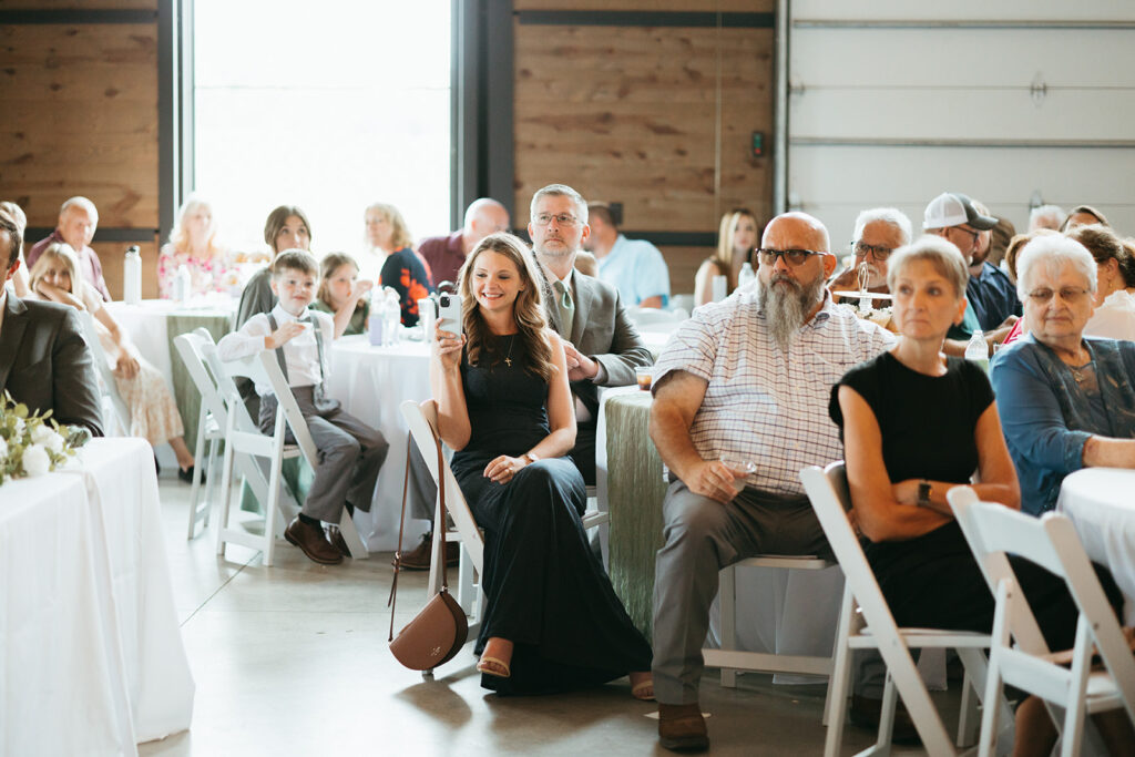 Second Photographer captures guest snapping a photo of bride and groom